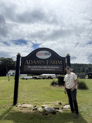 Jackie Spinnell
Olivia Adams Mancivalano stands next to a new sign for the Adams Farm. She is planning to launch the farm’s newest chapter on Labor Day weekend.